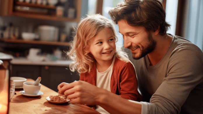 Grow retirement - father and daughter smiling together while having snacks, sitting on the lap.